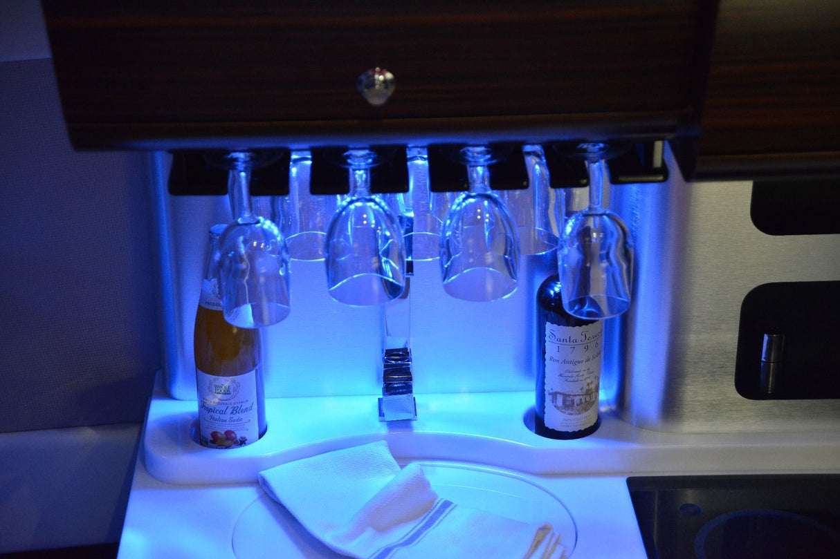 Mini Rail2 LED utility light, compact and water-sealed, versatile color options, sleek design on boat next to wine rack.