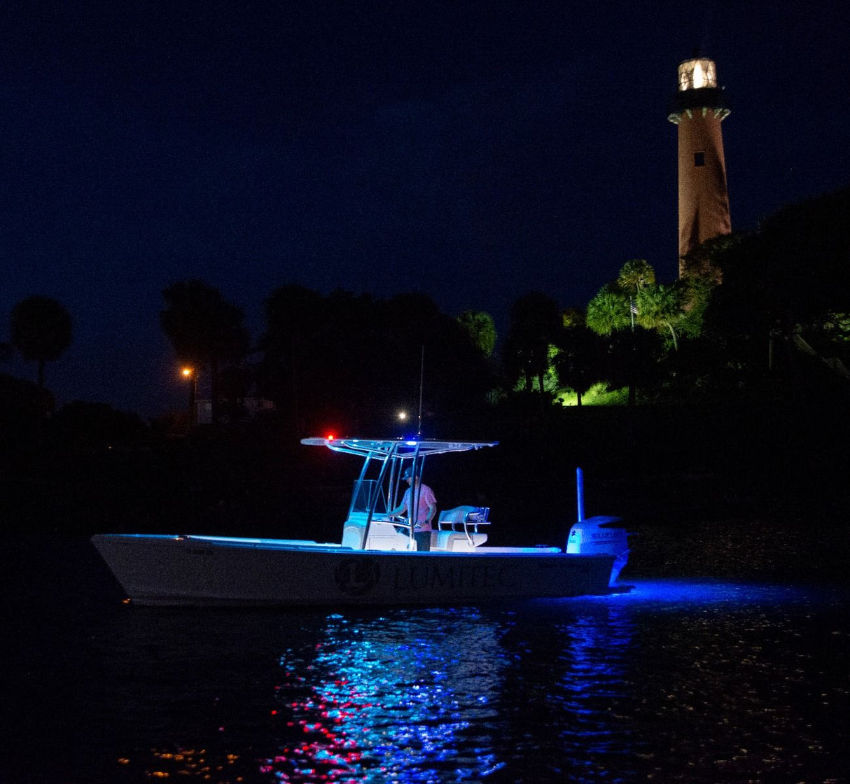 SeaBlaze Quattro Spectrum underwater light marine-grade bronze housing at night on center console jupeter lighthouse.